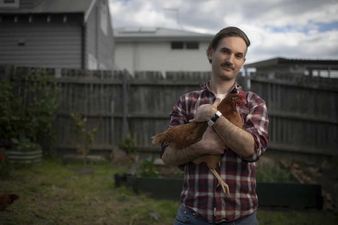 A picture of Ben Abraham holding a chicken